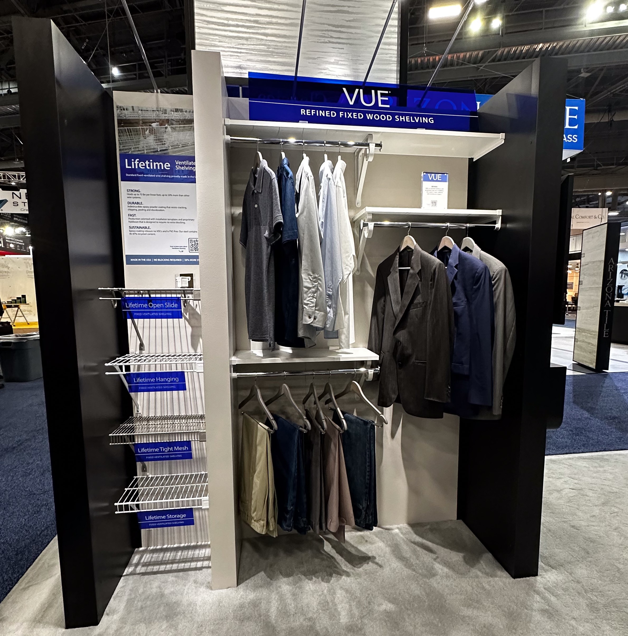 Organized Living Booth Wire & UE Vignette with signage and men's clothing.