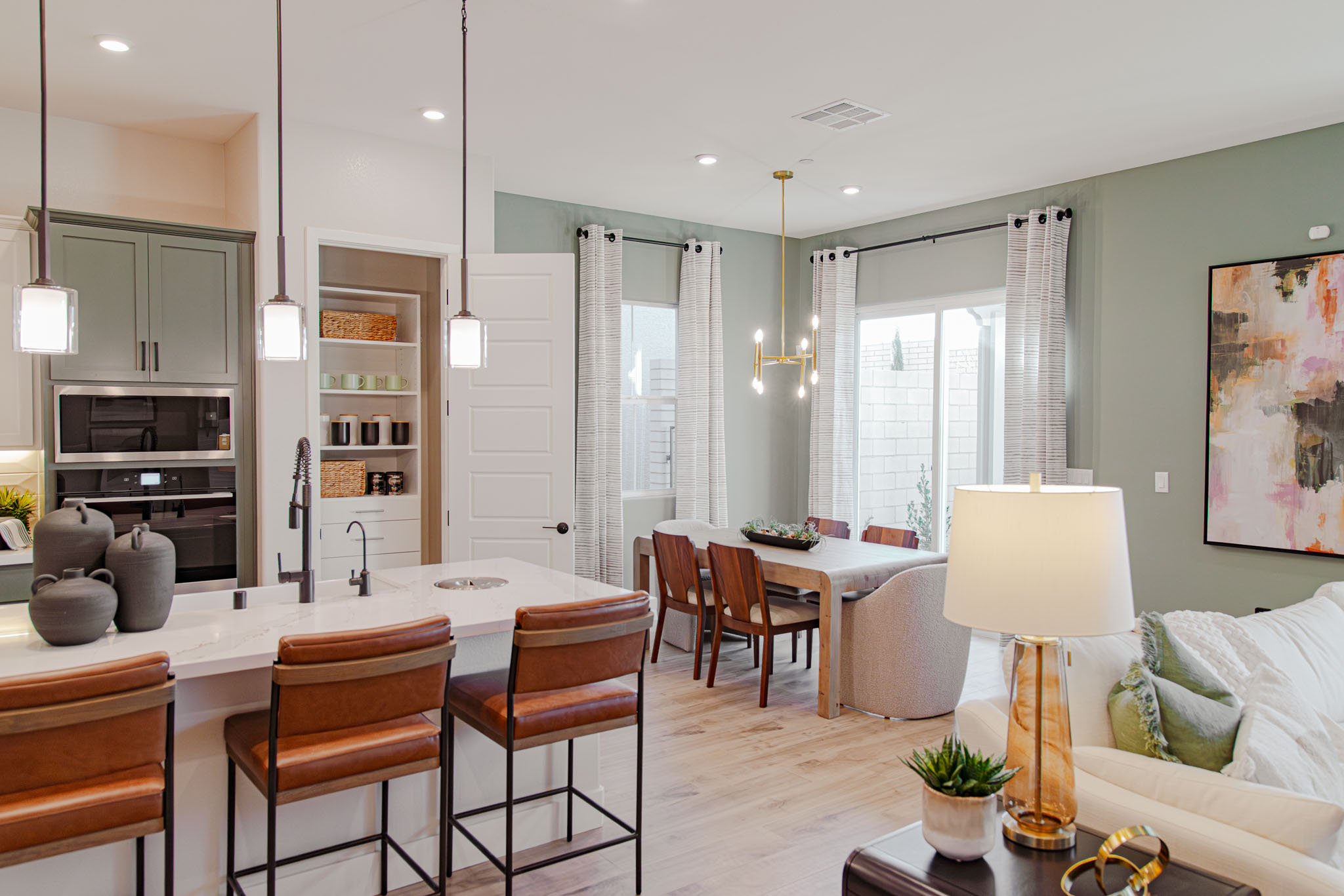 Beazer Homes with a reach-in pantry with kitchen and living room background with neutral decor.