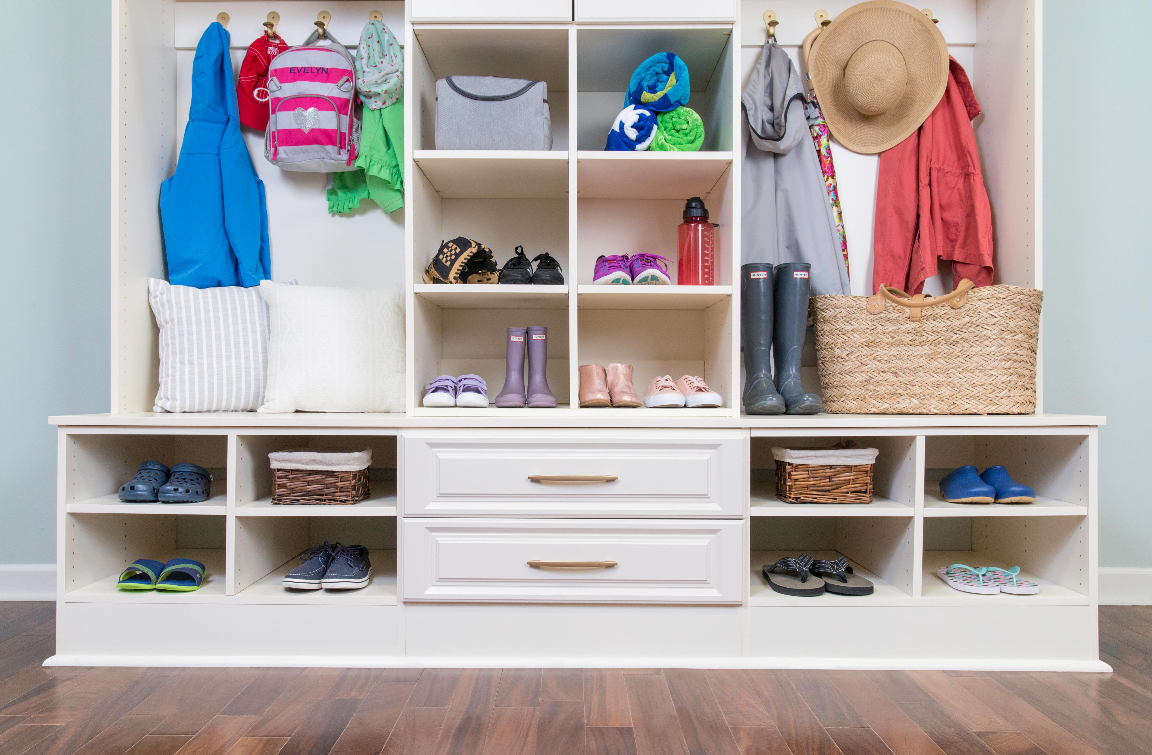 Classica Bisque Mudroom with adult and children clothing.