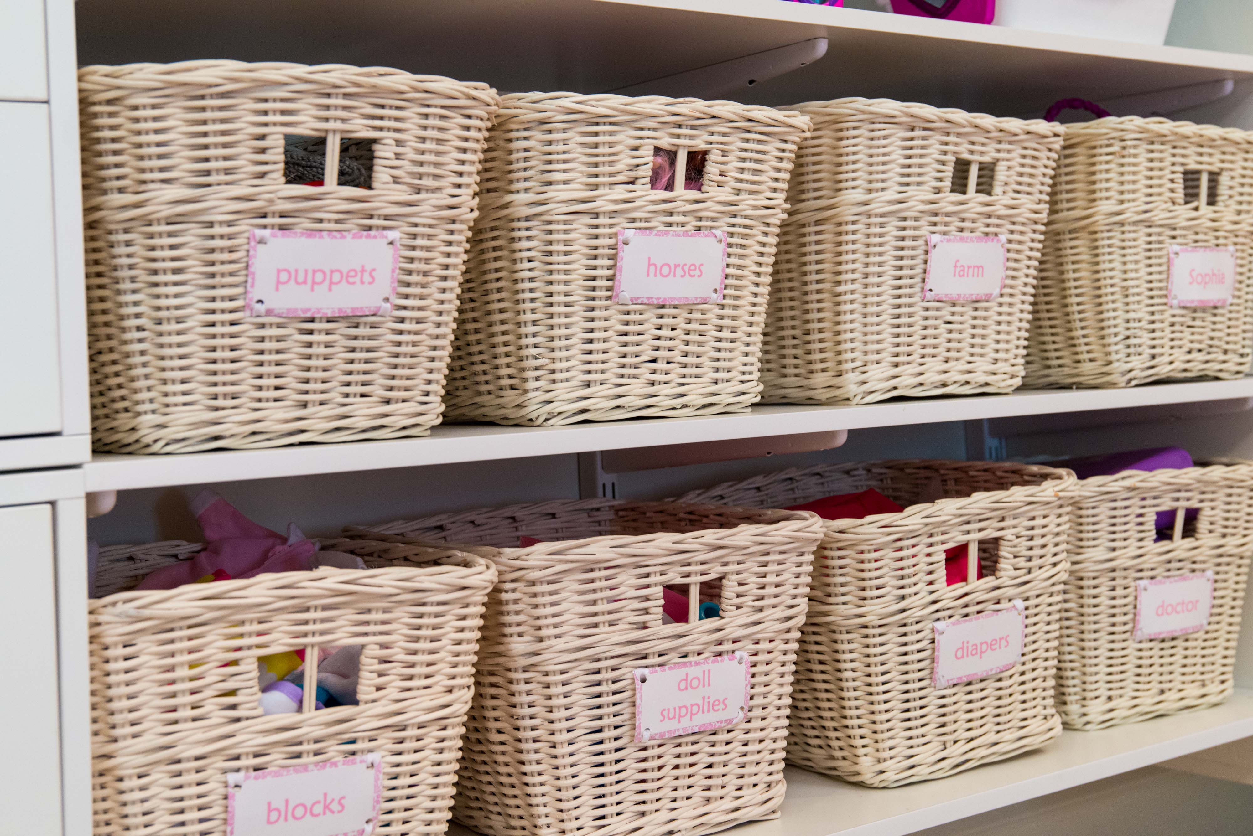 Close up of toy baskets in freedomRail Organization System with words,