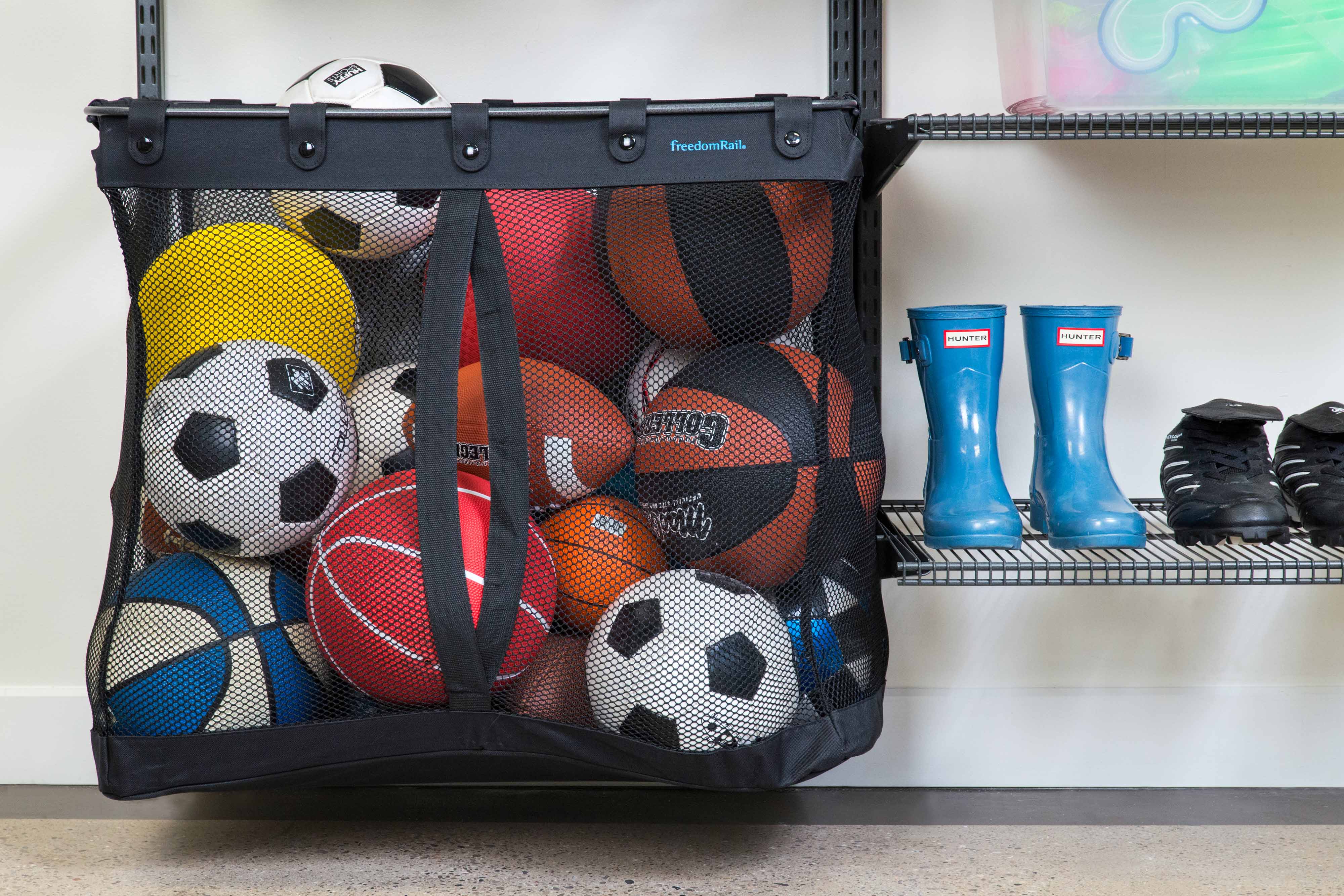 freedomRail Garage Sports Basket with sports balls and rain boots.