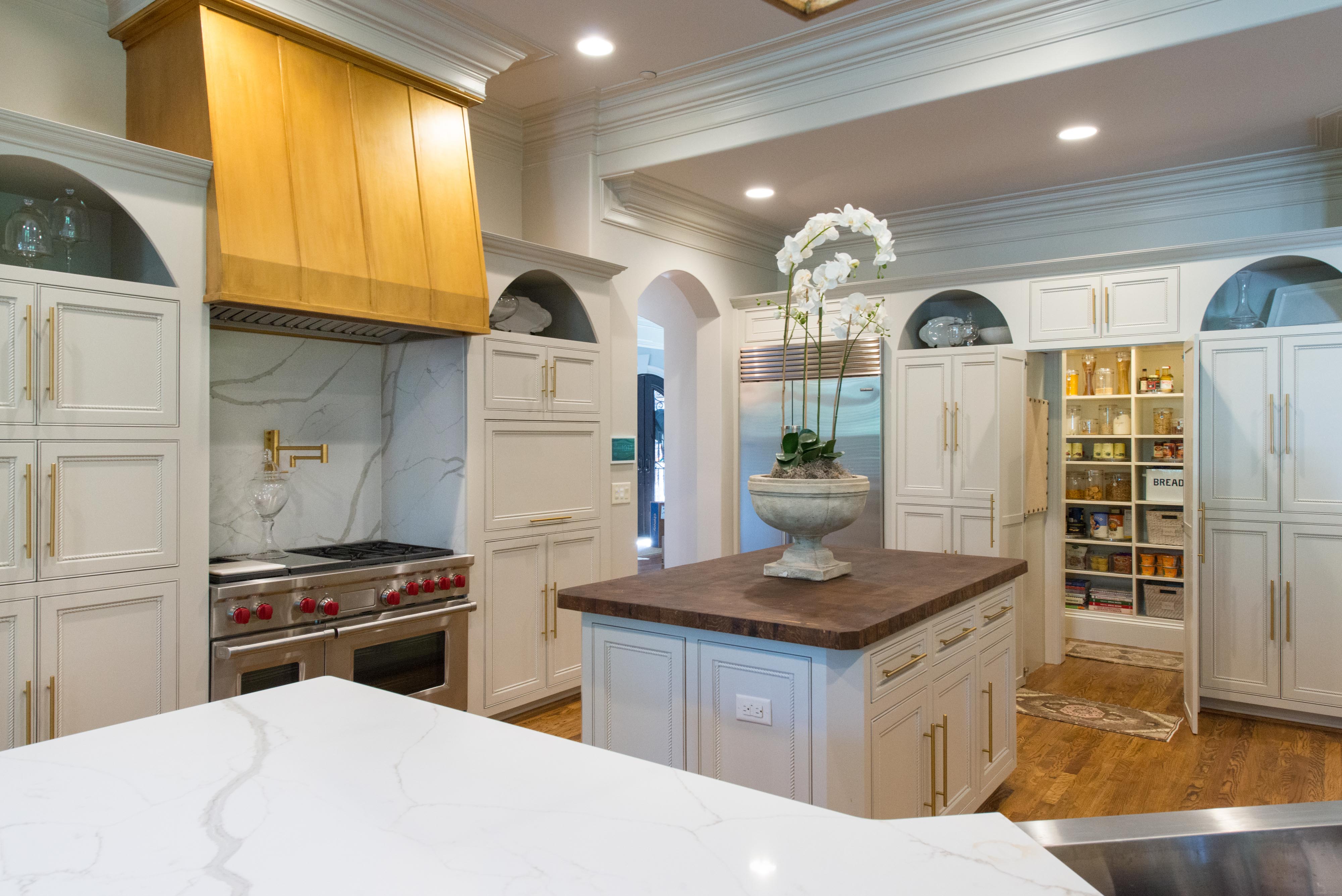 Organized Kitchen with white cabinets, organized pantry, and clean countertops.