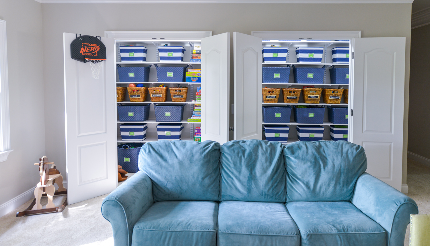 Easy Kid's Room Organization freedomRail Reach-in closet in White with baskets and games.