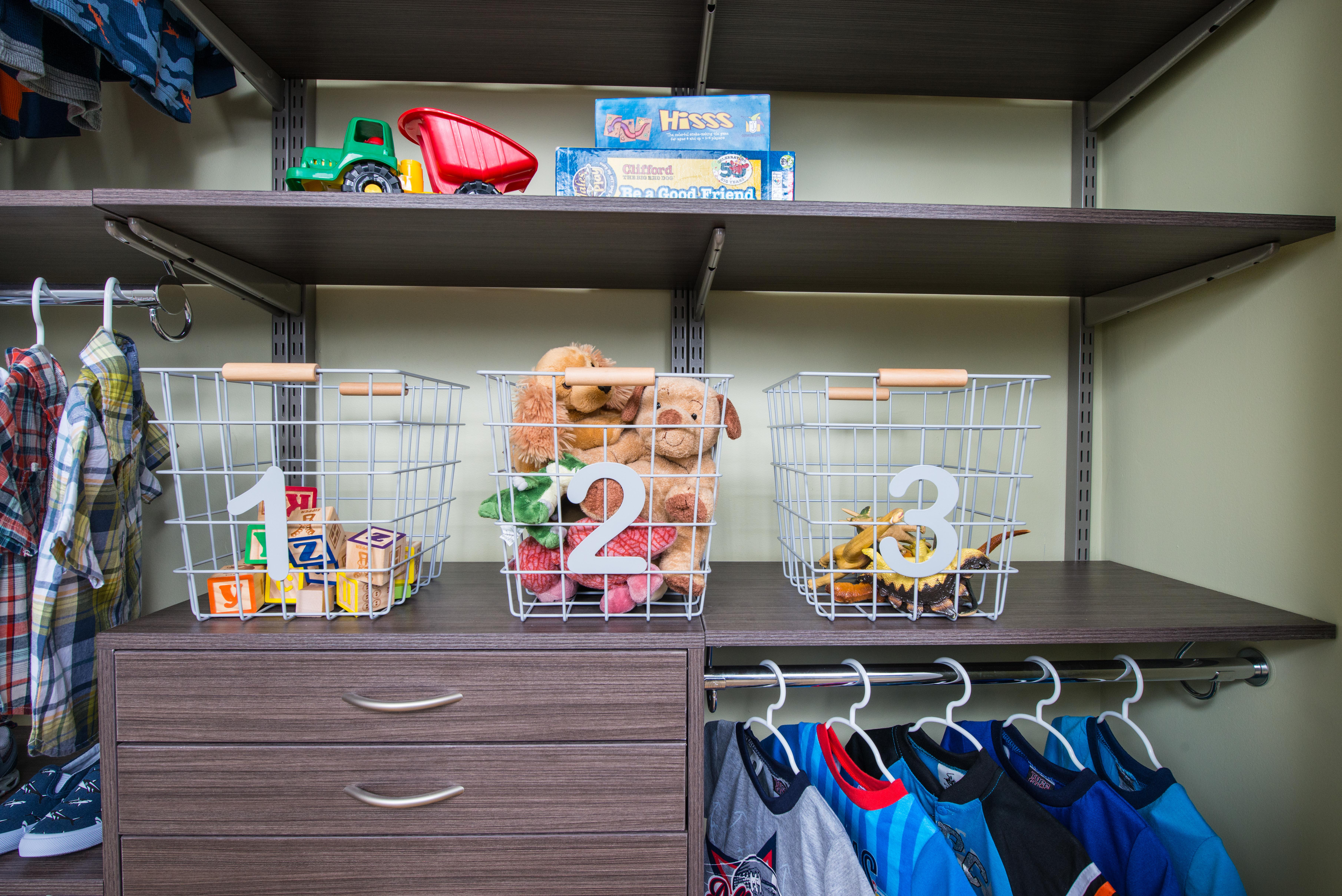 Easy Kid's Room Organization freedomRail Reach-in closet in Driftwood Live with child's clothes and toys.