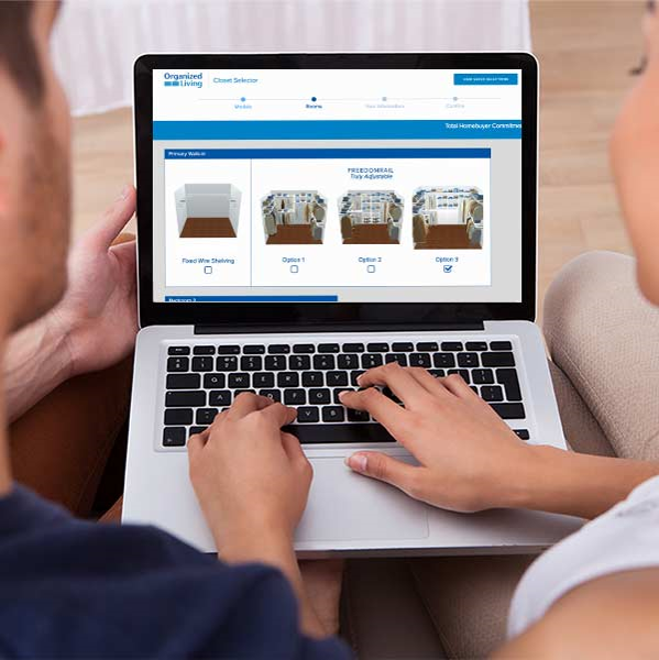 Closet Selector Software with 2 people holding laptop.