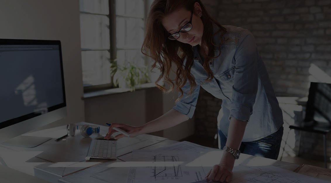 Female Architect Looking at blueprints