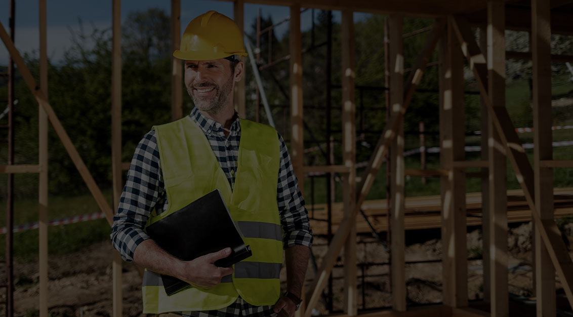 Builder on construction site wearing hard hat