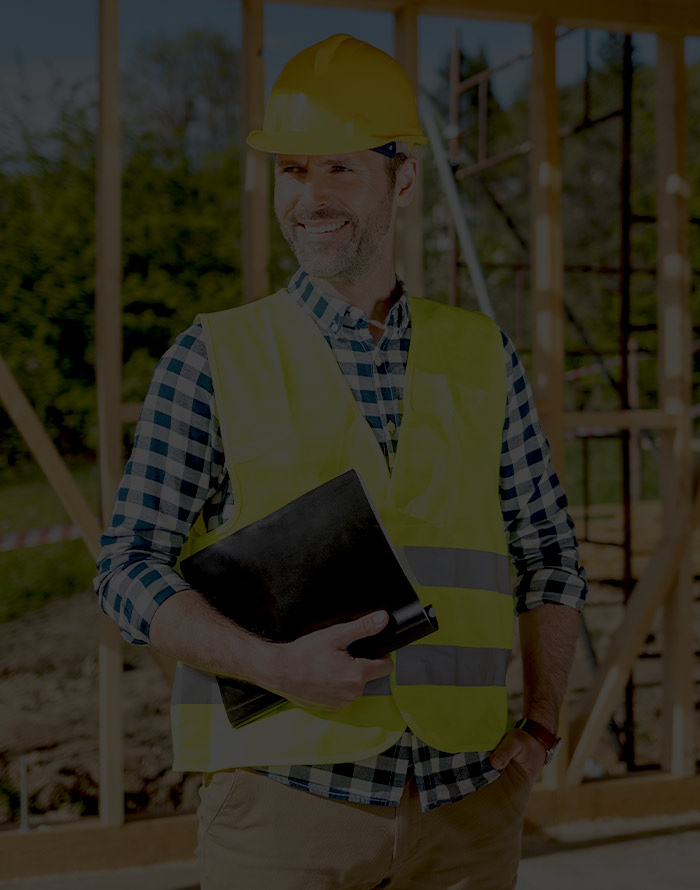 Builder on construction site wearing hard hat