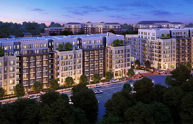 Eight-story brick and white apartment complex with trees, Camden Buckhead.