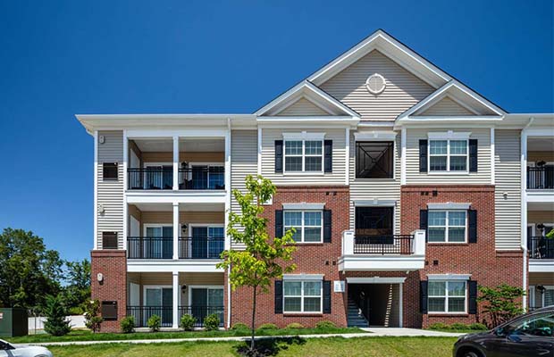 Three-story brick and white apartment complex, Gabrielle Run.